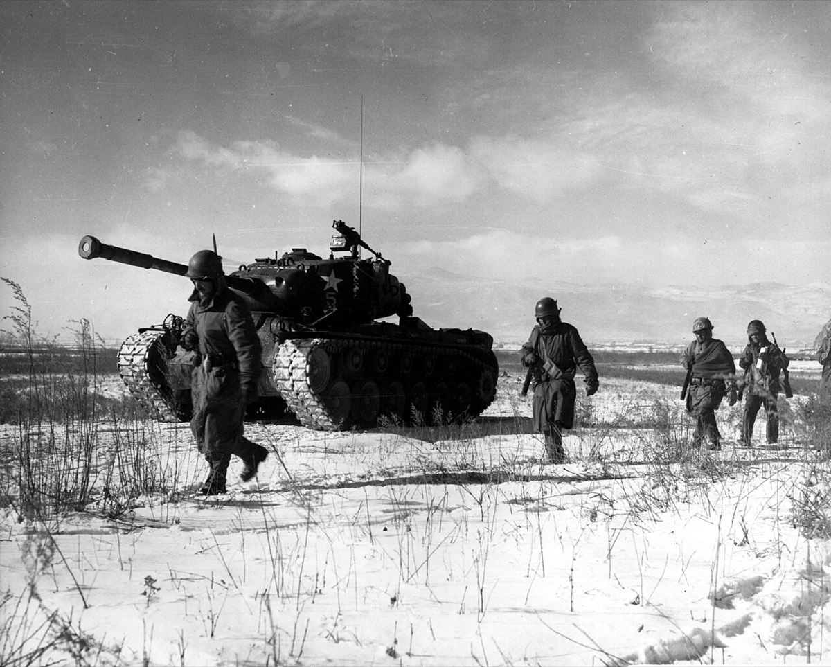A column of troops and armor of the 1st Marine Division move through communist Chinese lines during their successful breakout from the Chosin Reservoir in North Korea.